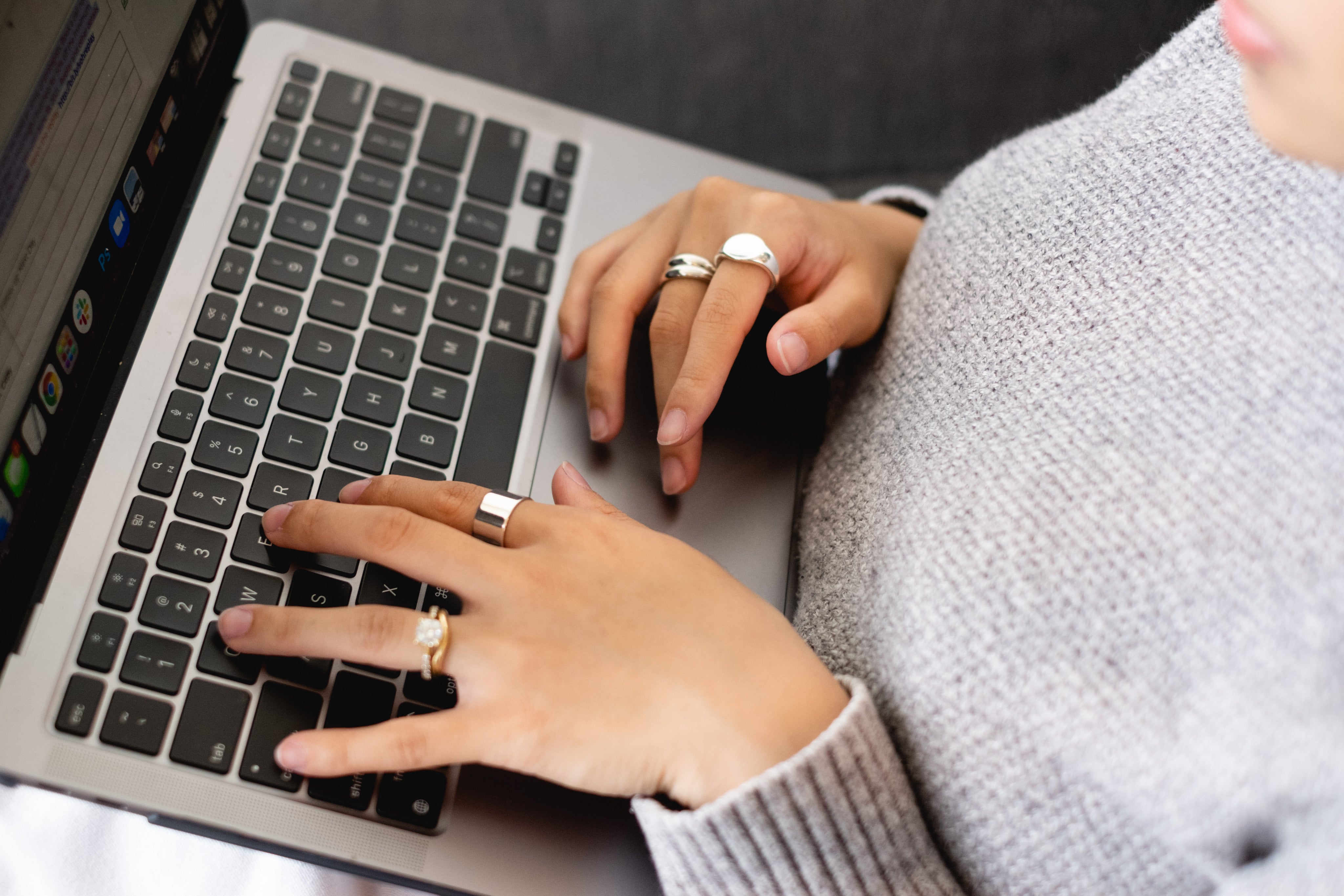 hands-with-gold-rings-type-on-a-laptop.jpg